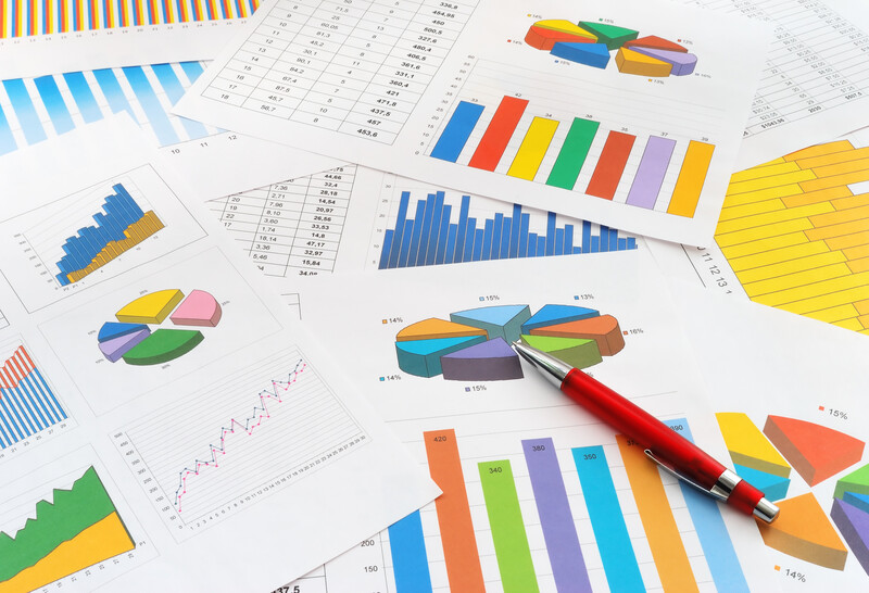papers with charts and graphs with pen_canstockphoto5373165