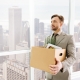 employee holding box with belongings and standing in the office_canstockphoto46554376