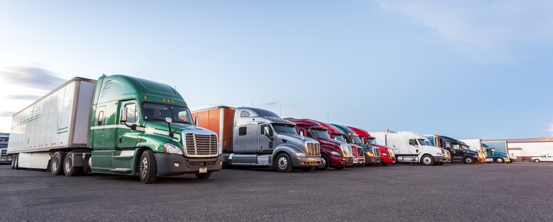 several trucks parked in parking lot_canstockphoto21151162 800x533