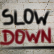 slow down painted on brick wall_canstockphoto22321319 800x533
