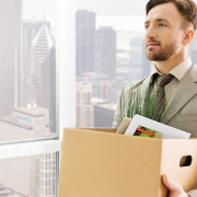 employee-holding-box-with-belongings-and-standing-in-the-office_canstockphoto46554376-800x315